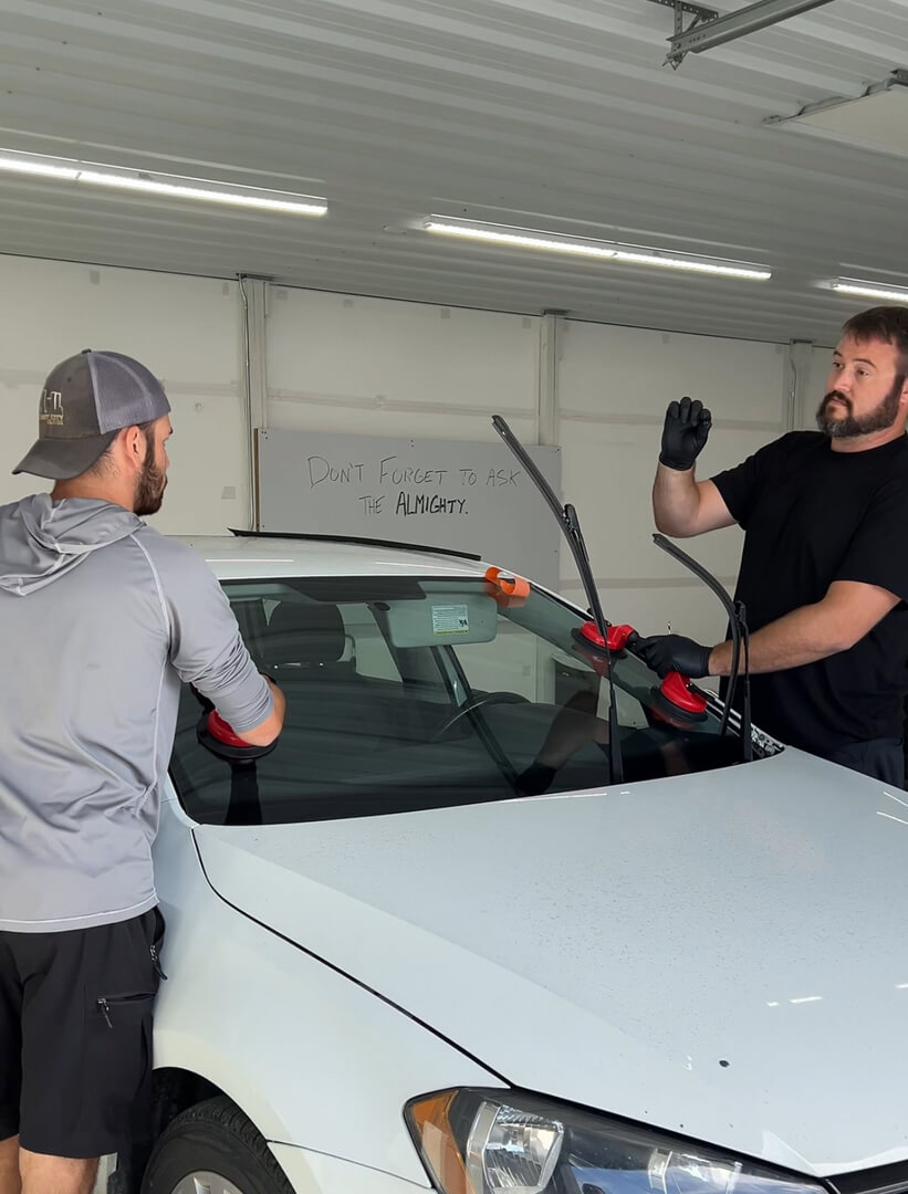 2 men replacing a window at Carr Tech