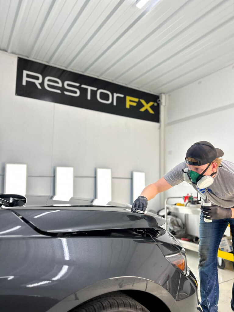 Carter applying ceramic coating to a vehicle at Carr Tech